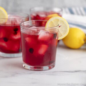 Glasses of Huckleberry Lemonade with lemon slices.