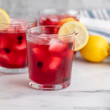Glasses of Huckleberry Lemonade with lemon slices.