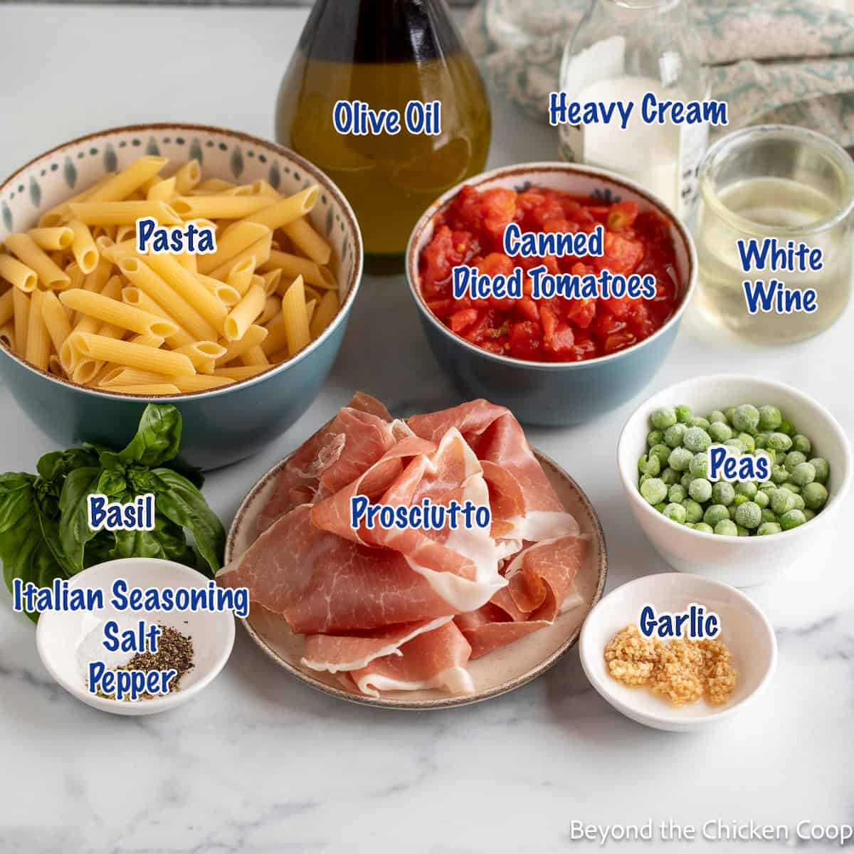 Bowls filled with pasta, tomatoes, peas, garlic, and prosciutto. 