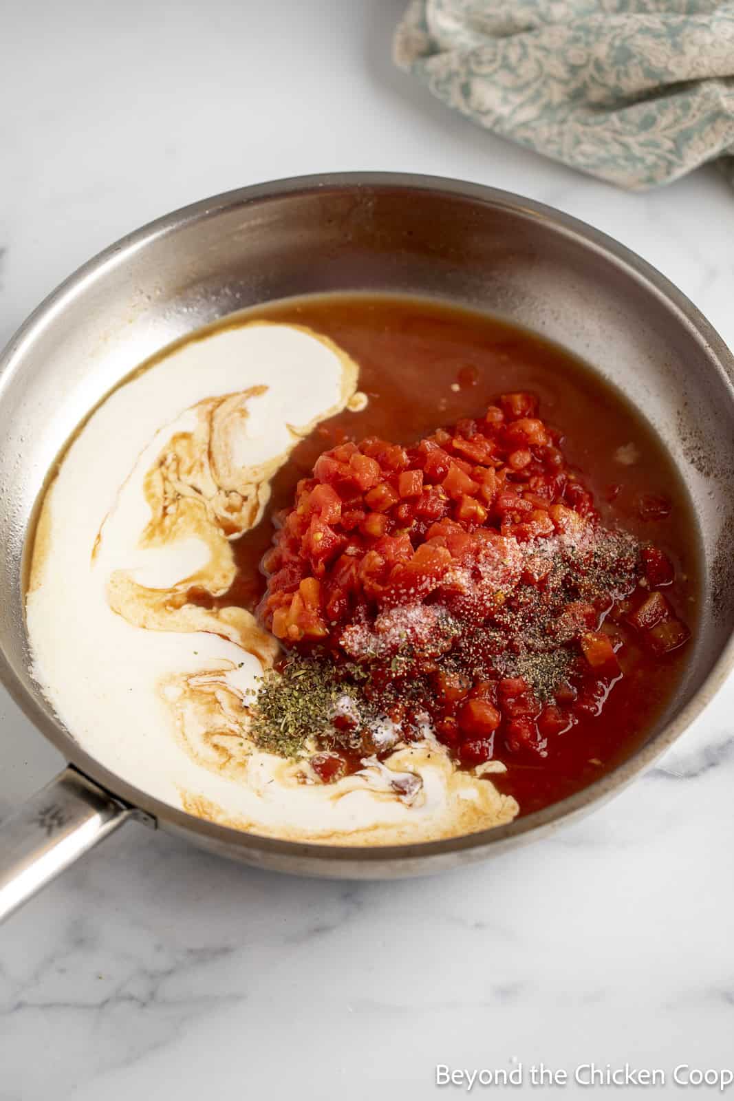 Making a sauce with cream wine, tomatoes and herbs. 