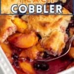 A juicy fruit cobbler in a white casserole dish.