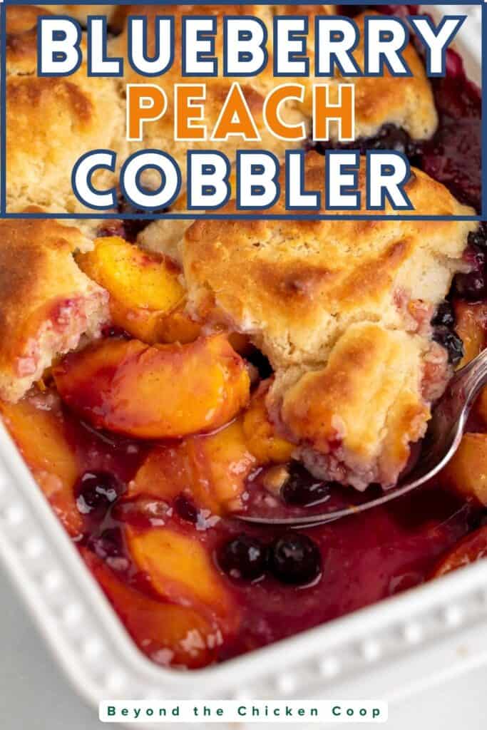 A juicy fruit cobbler in a white casserole dish.