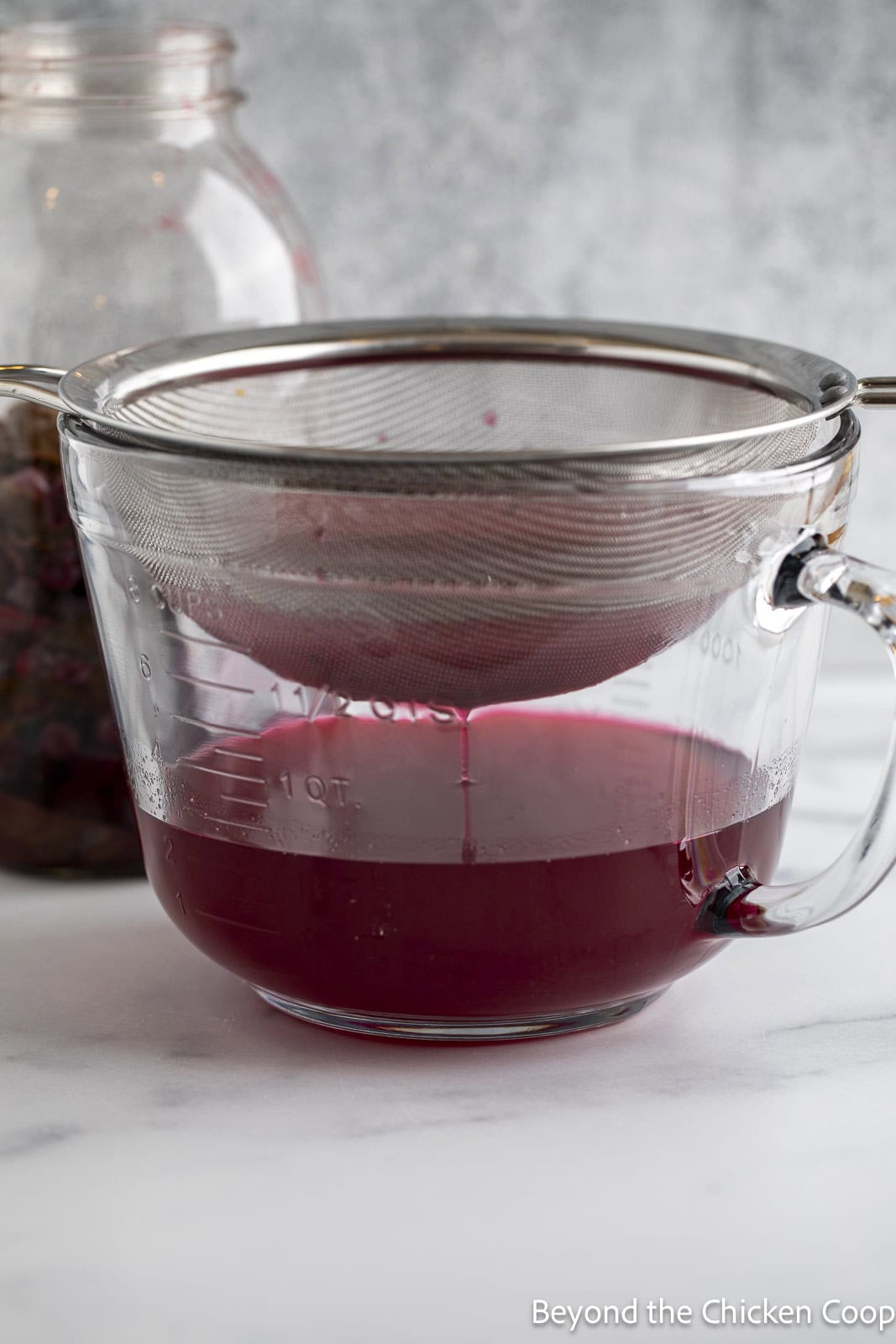 Straining vinegar with a sieve. 