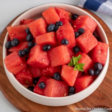 Blueberry Watermelon salad with mint in a white bowl.