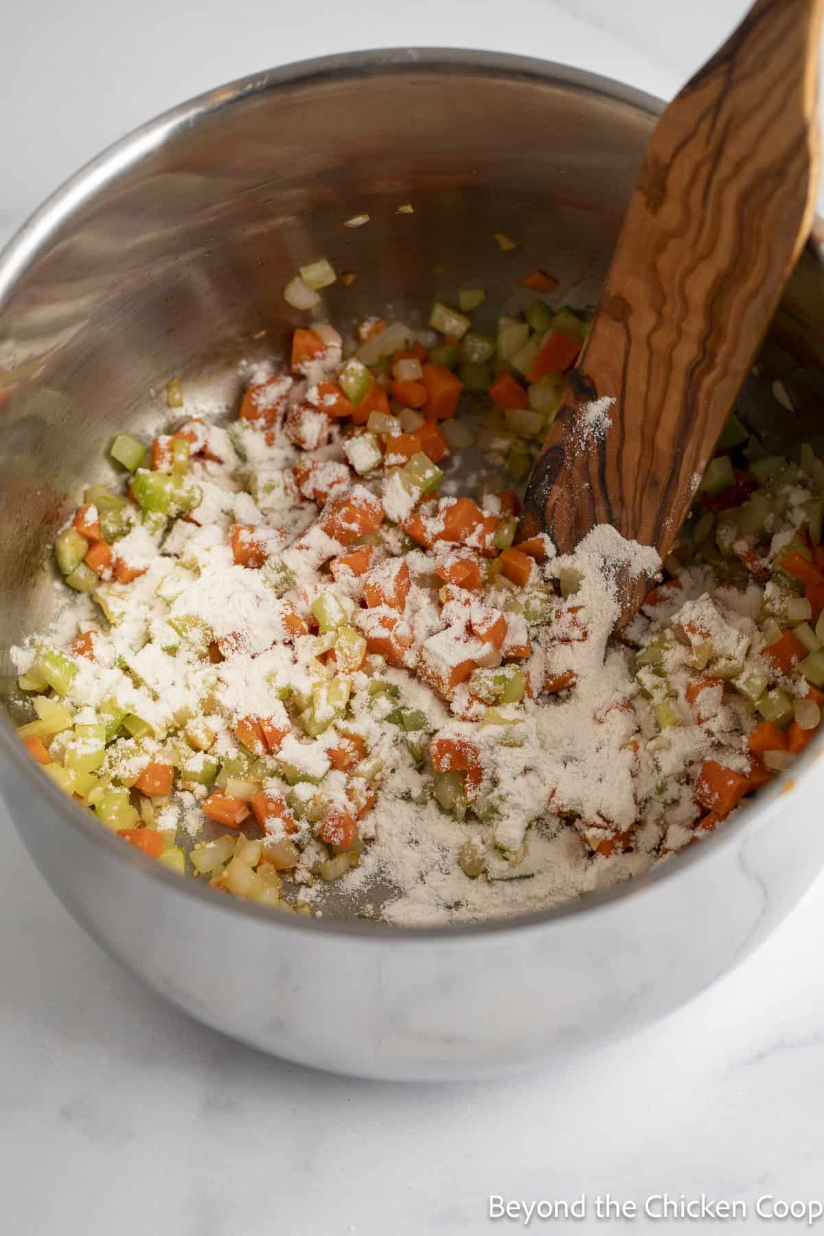 Flour on cooked carrots, celery, and onions.