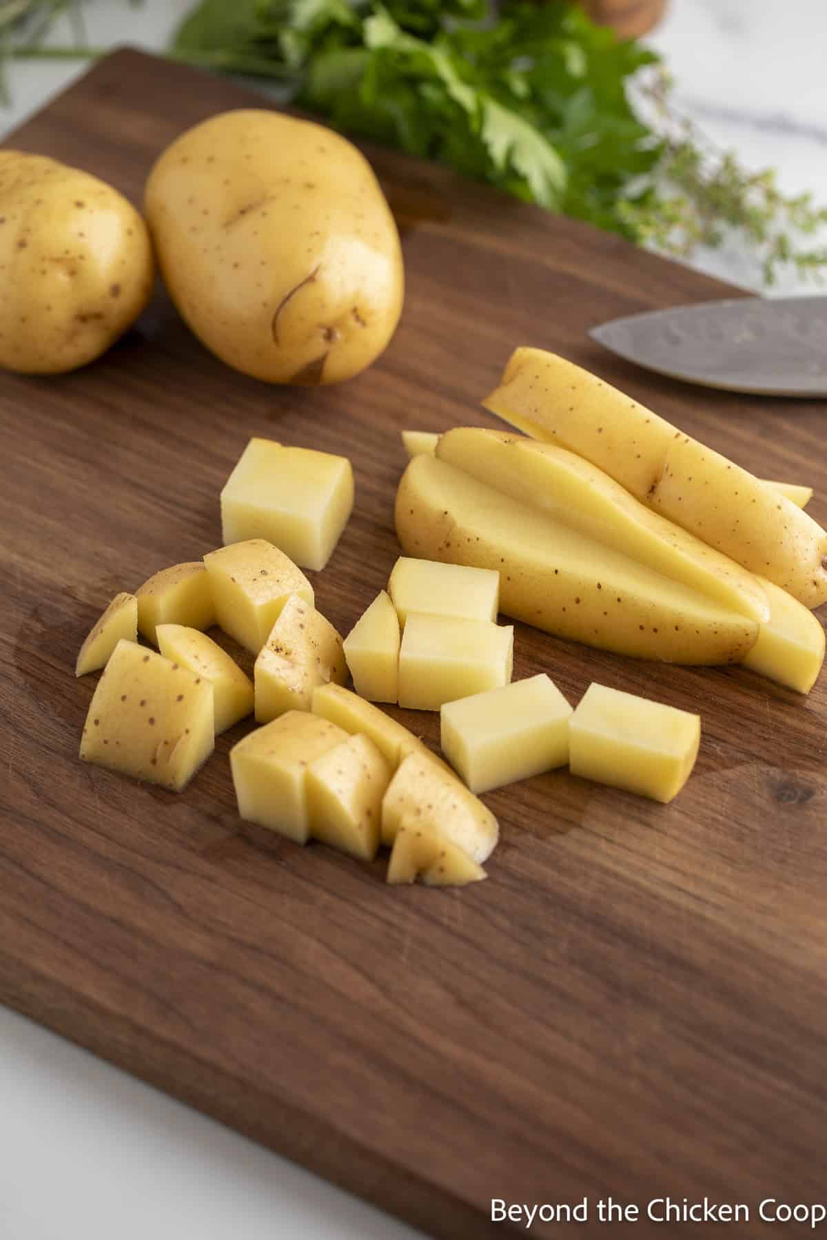 Cutting Yukon gold potatoes.