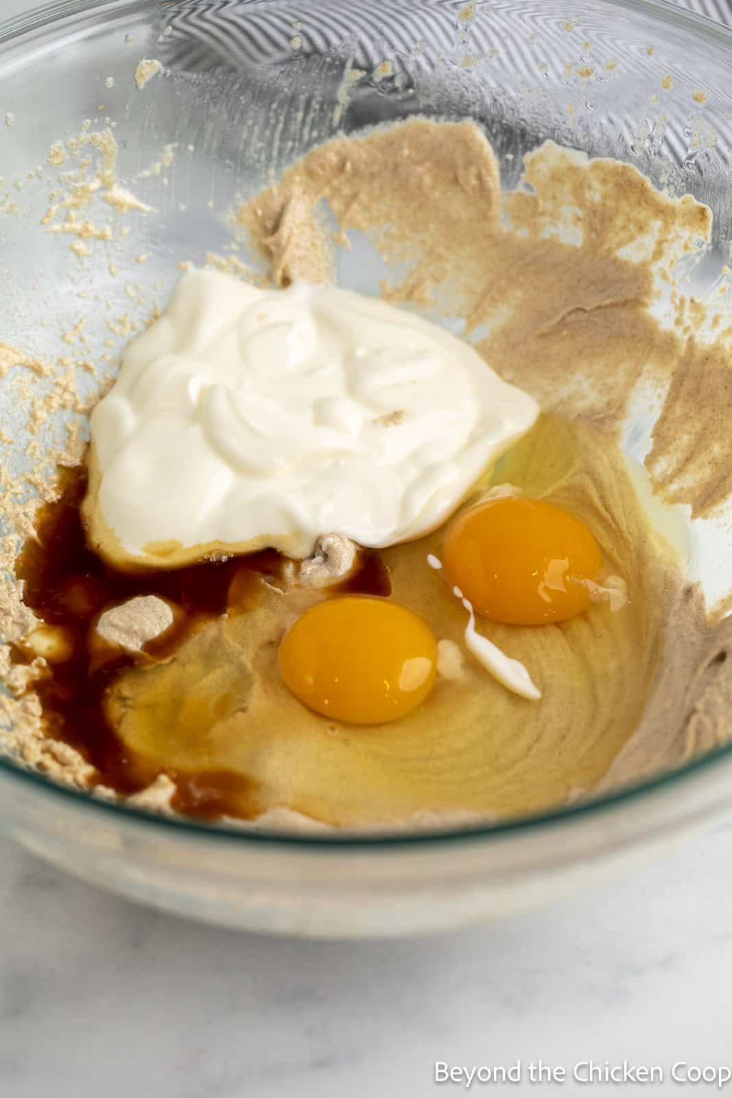 Muffin batter in a bowl with eggs.