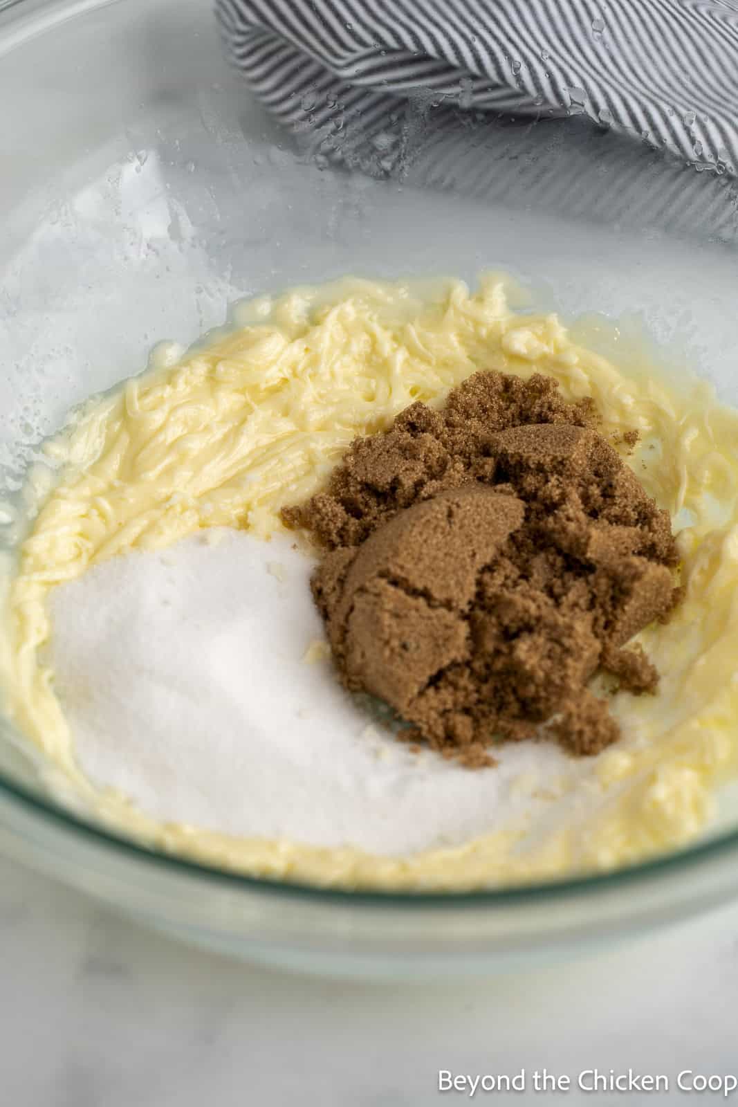 Adding sugar to batter.