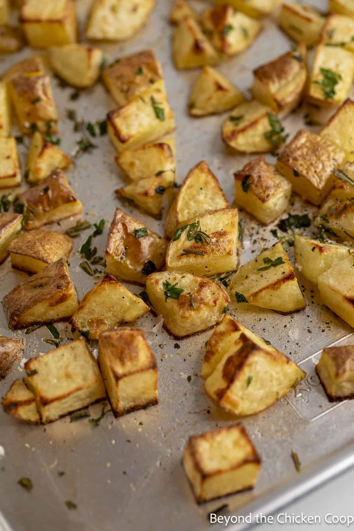 Cooked potatoes on a baking sheet.