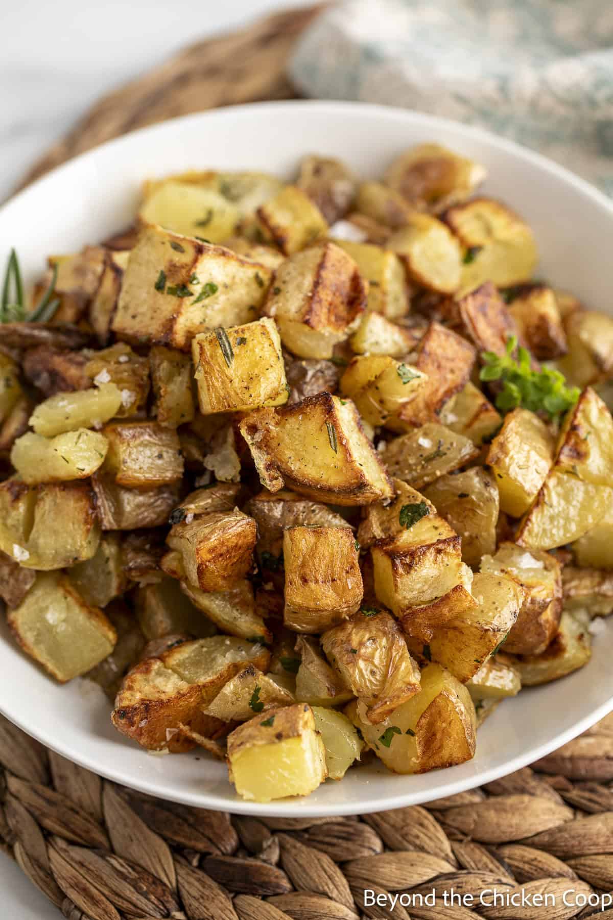 Cubed potatoes in a white bowl.
