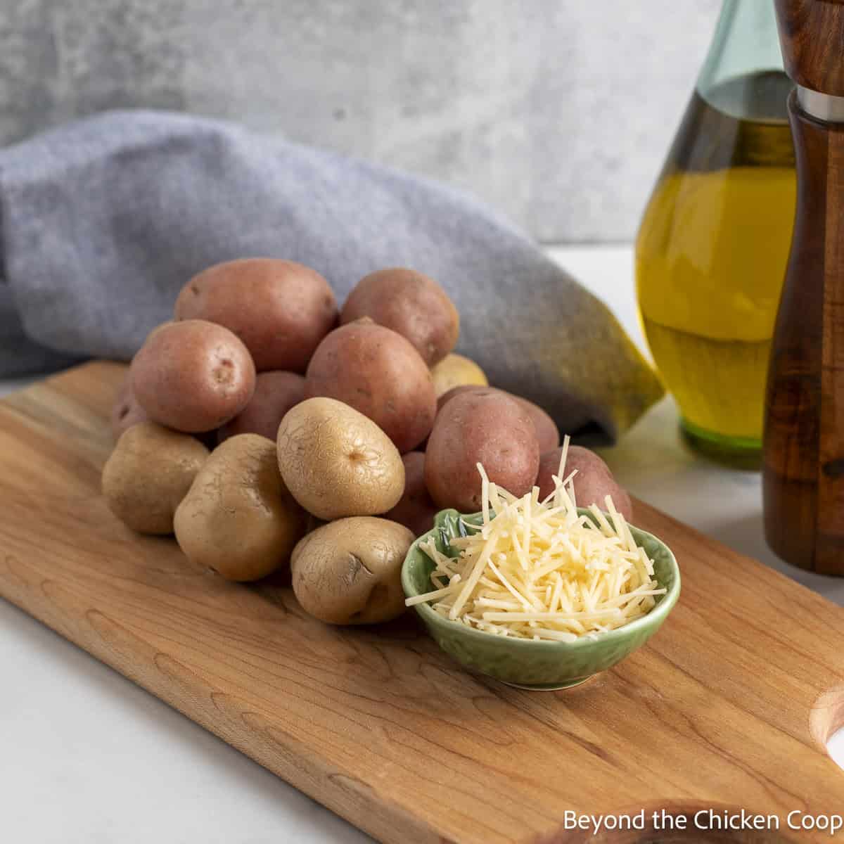 Baby potatoes, Parmesan cheese, and a bottle of olive oil.