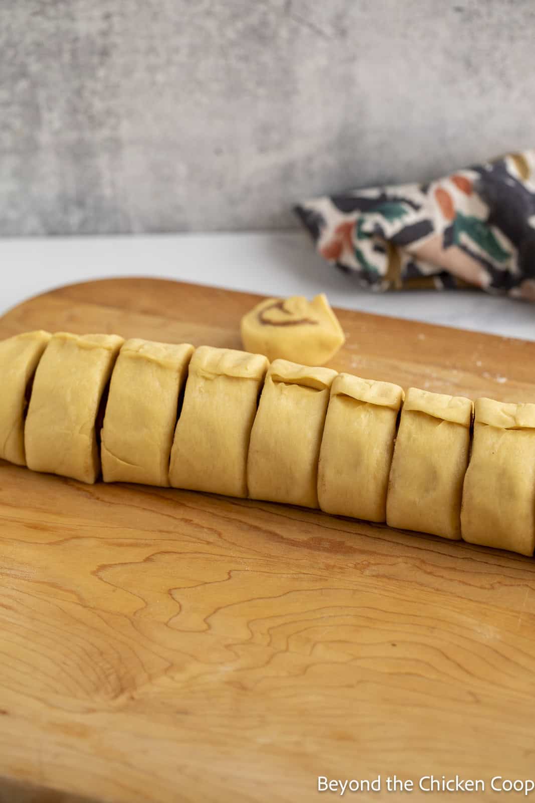 Sliced cinnamon rolls on a board. 