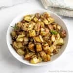 Roasted Yukon potatoes in a white bowl.