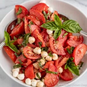 Tomato Basil Salad with mozzarella in a white bowl.