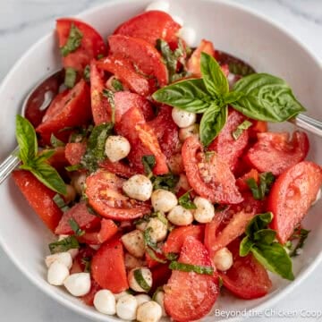 Tomato Basil Salad with mozzarella in a white bowl.