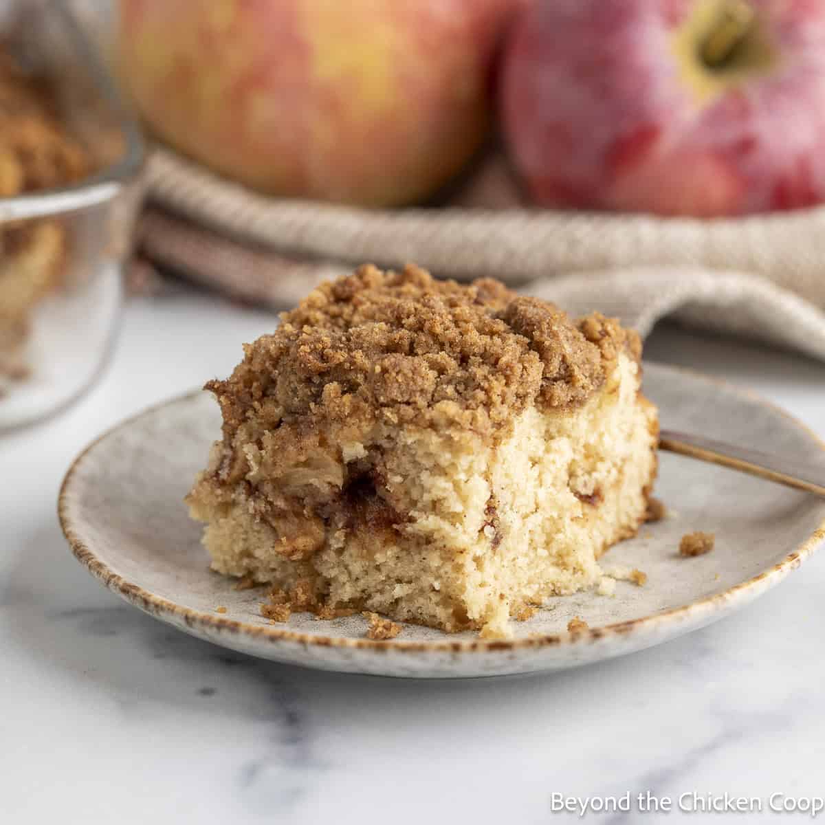 A slice of Apple Coffee Cake on a small plate.