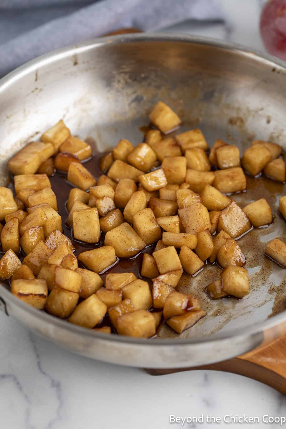 Cooked apple pie filling in a skillet.