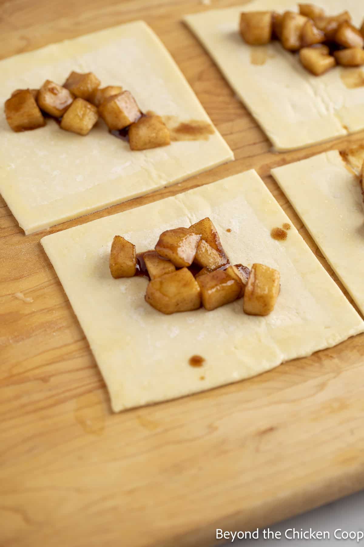 Apple pie filling on top of unbaked puff pastry.