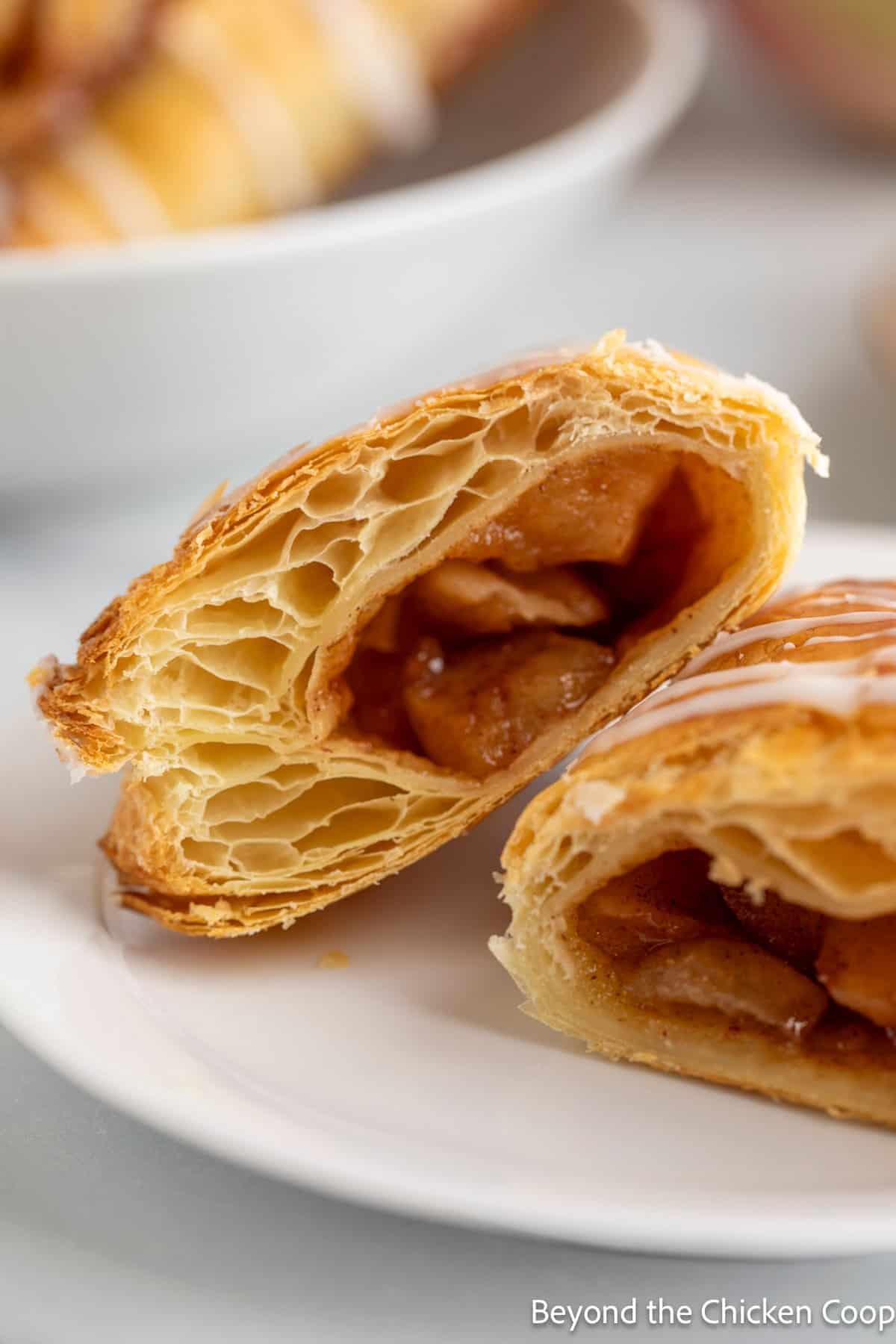 Puff pastry apple turnovers sliced in half.