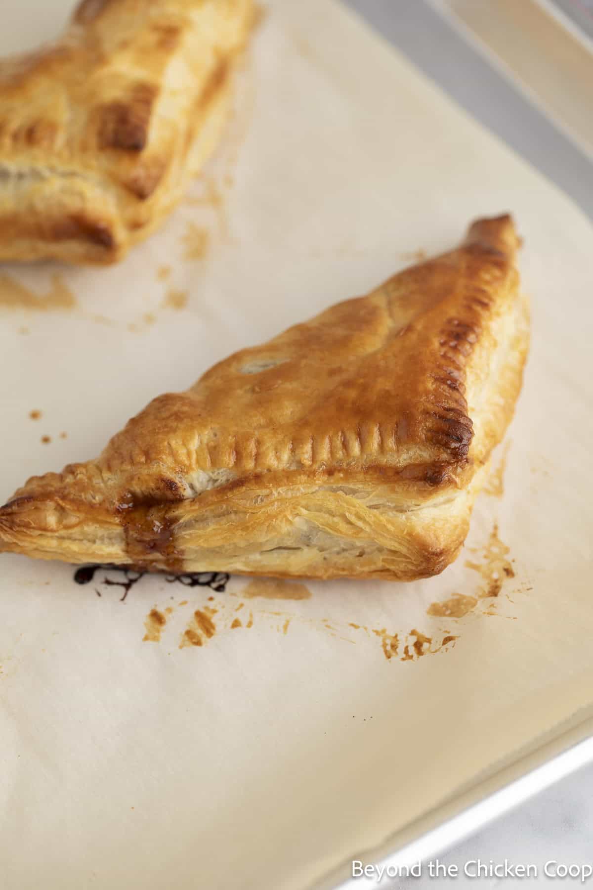 A baked turnover on a baking sheet.