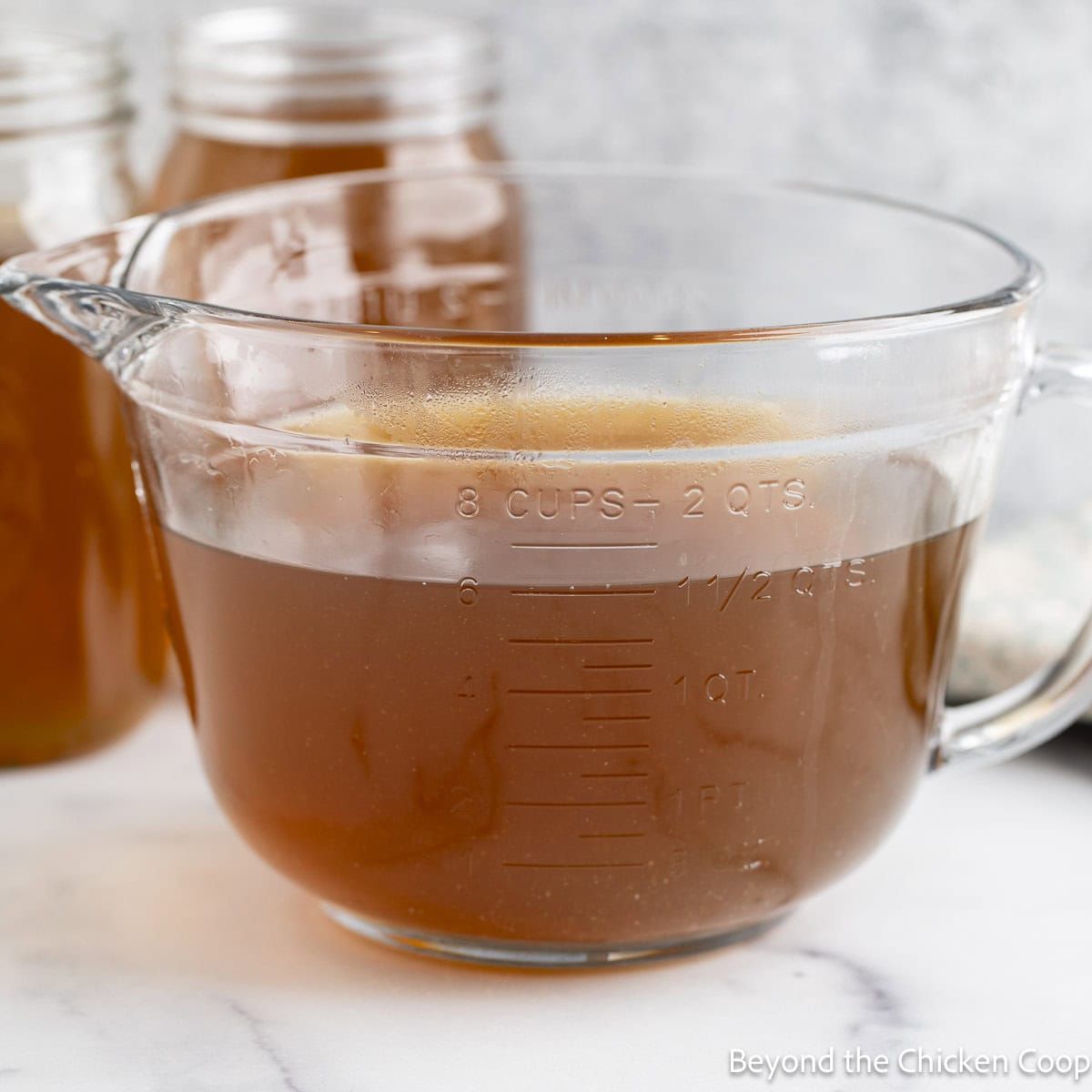 A large glass bowl filled with homemade stock.