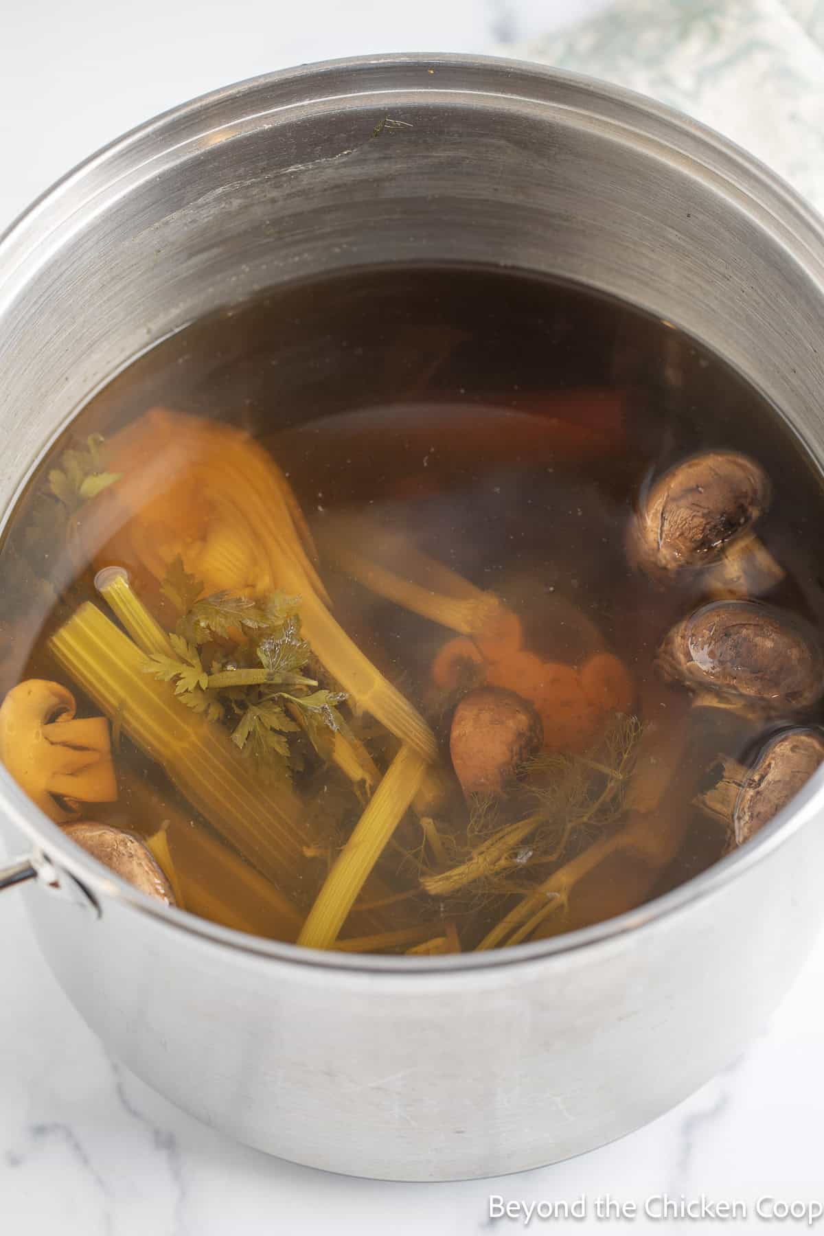 Cooked veggies in a large stockpot.
