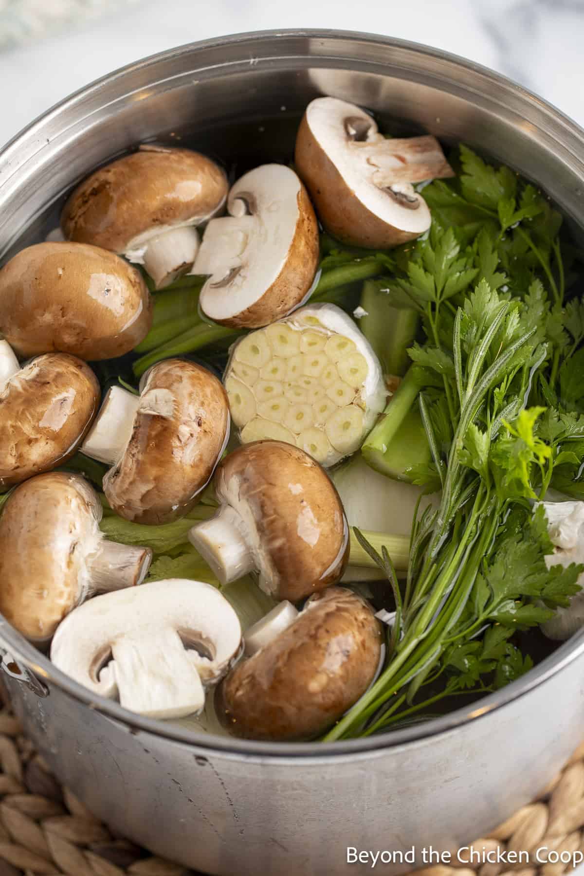 Fresh veggies in a pot filled with water.