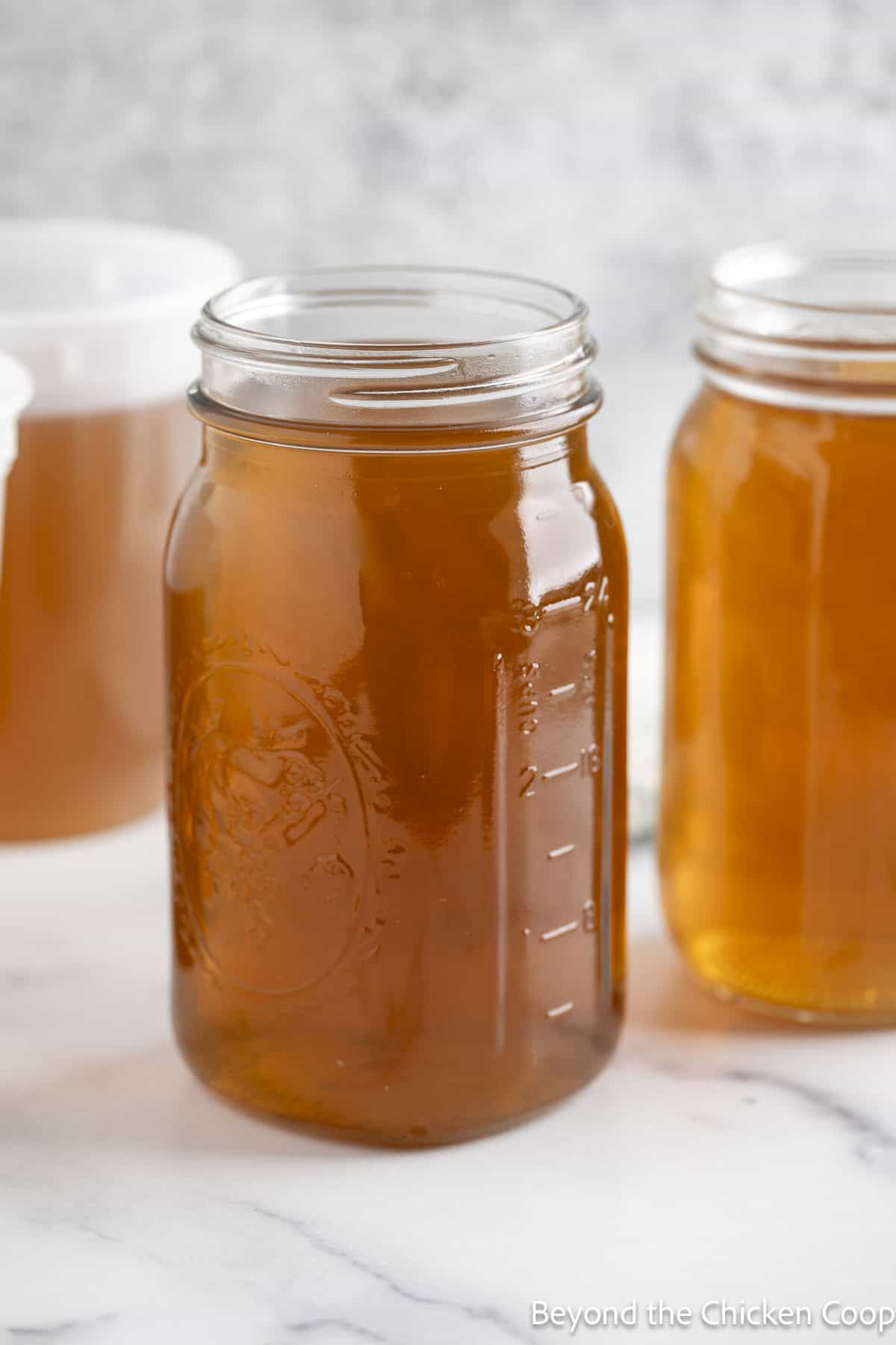 Veggie stock in glass quart jars.