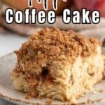 A slice of coffee cake with a crumb topping on a plate.