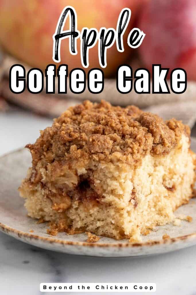 A slice of coffee cake with a crumb topping on a plate.