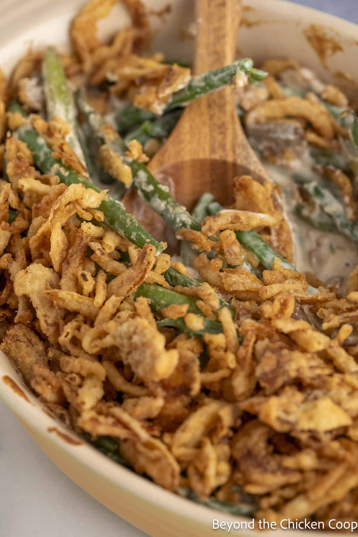 Green bean casserole topped with crispy fried onions.