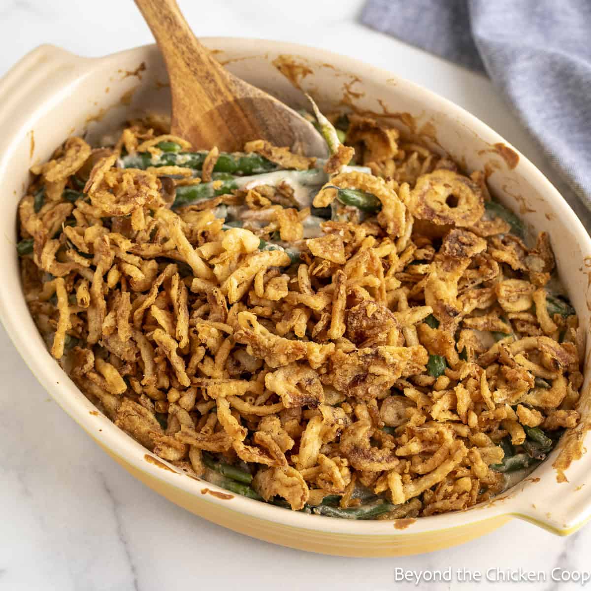 Homemade Green Bean Casserole in a yellow baking dish.