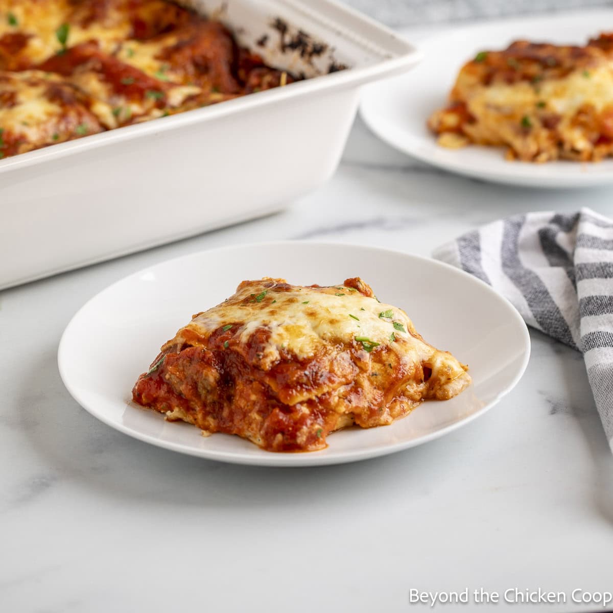 A slice of Italian Sausage Lasagna on a white plate.