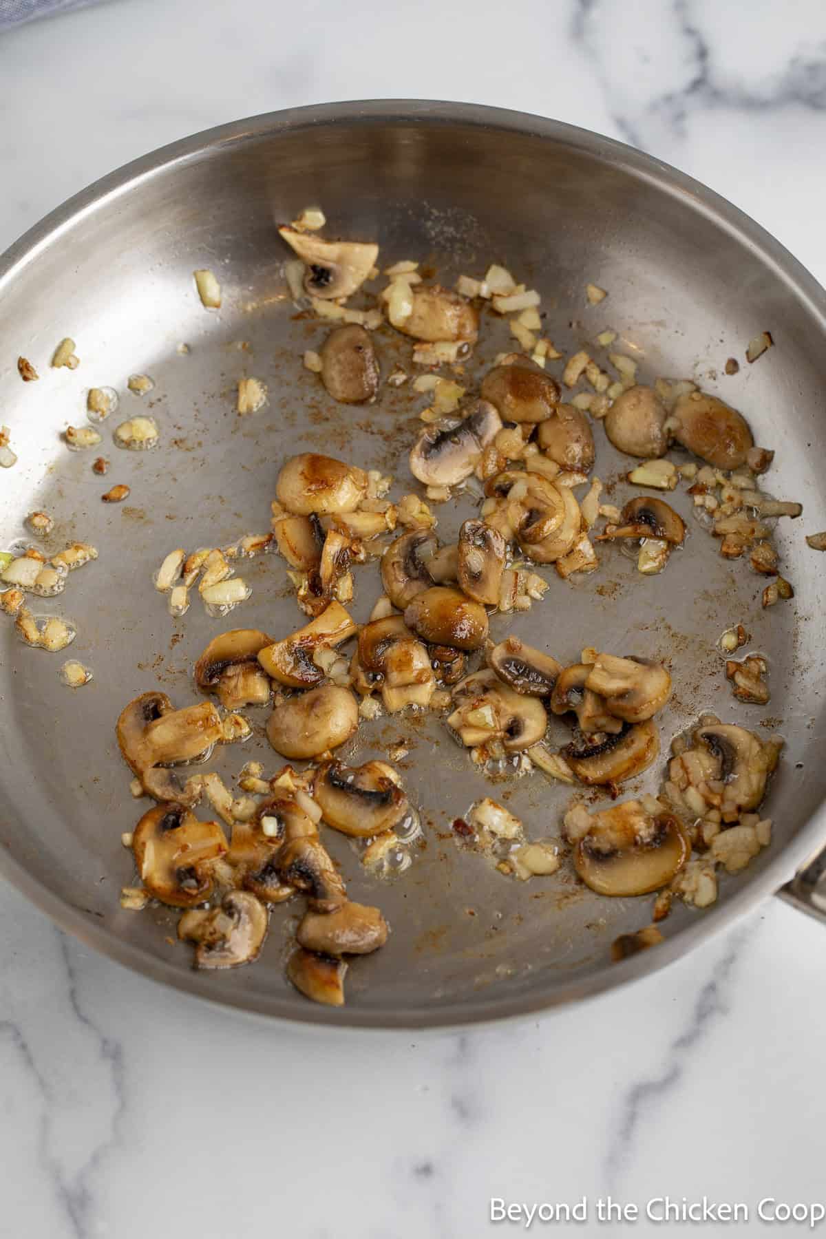 Browned mushrooms in a saute pan.