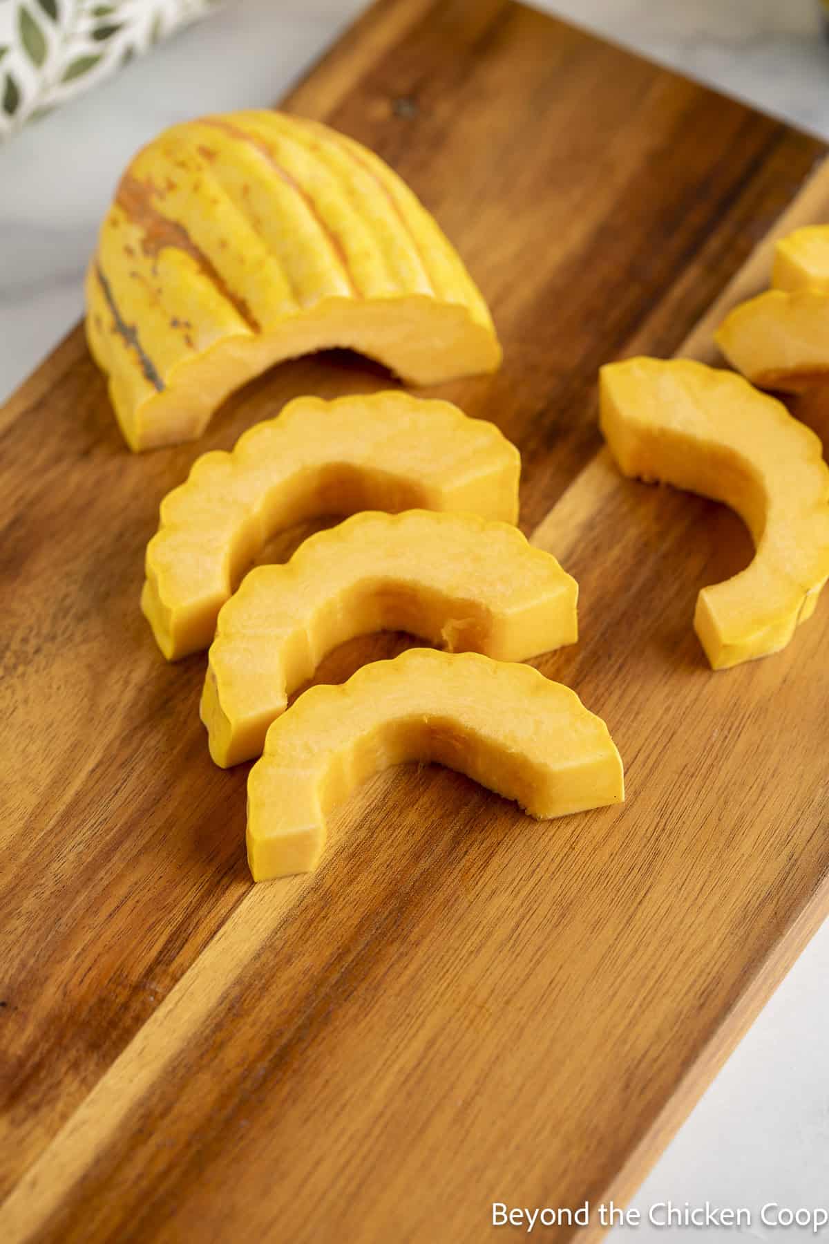 Slicing delicata squash into half circles.