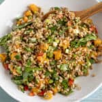 Farro Salad with roasted butternut squash and spinach in a white bowl.