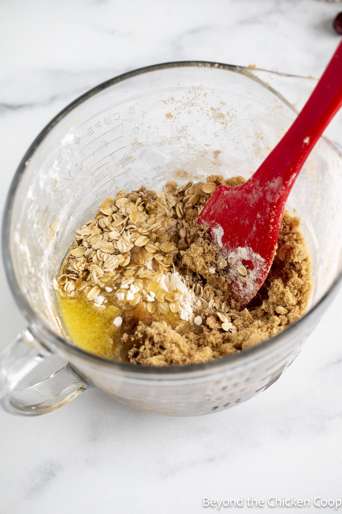 Mixing melted butter with oats and flour.