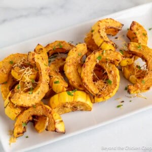 Roasted Delicata Squash on a white platter.
