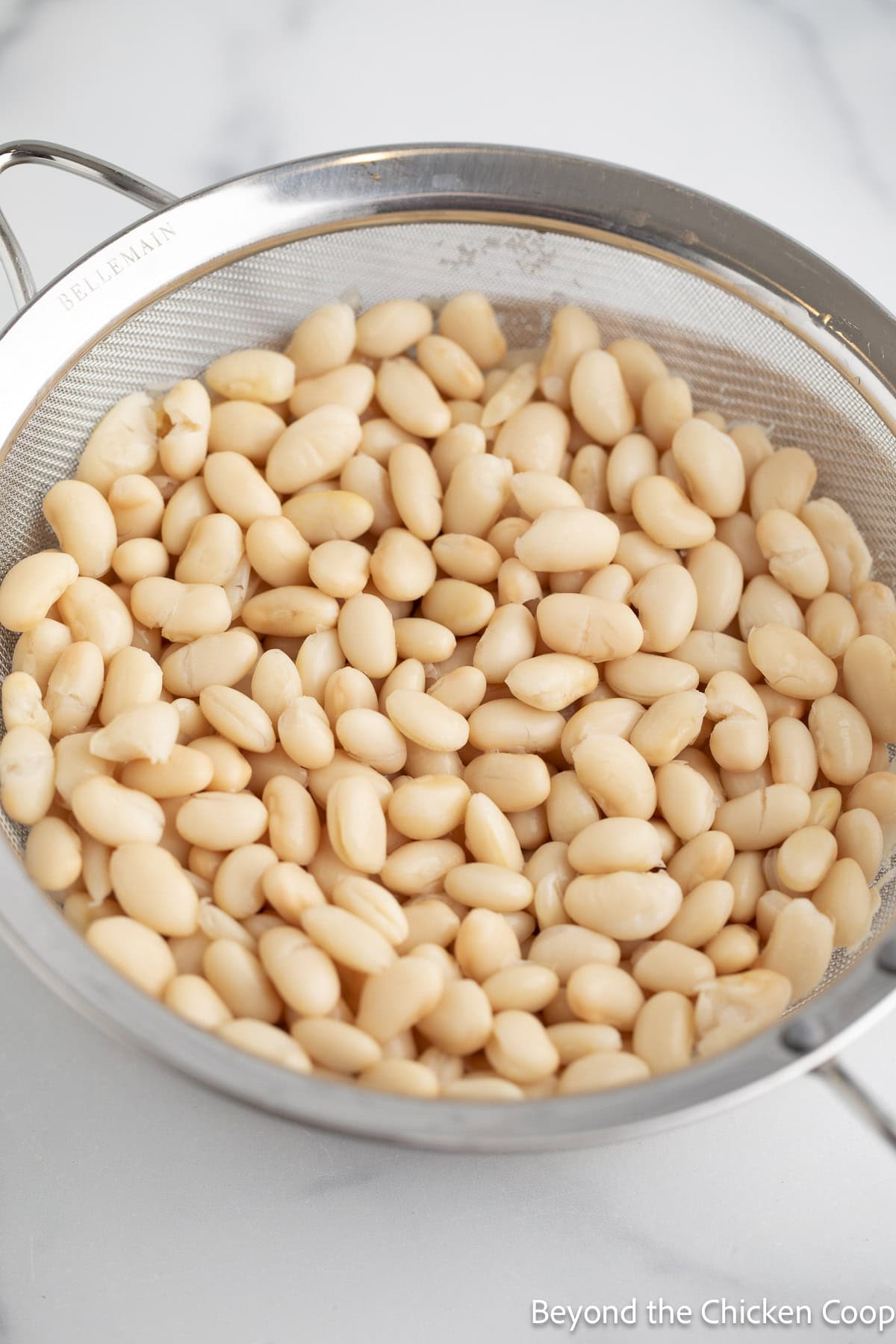 Drained beans in a sieve.