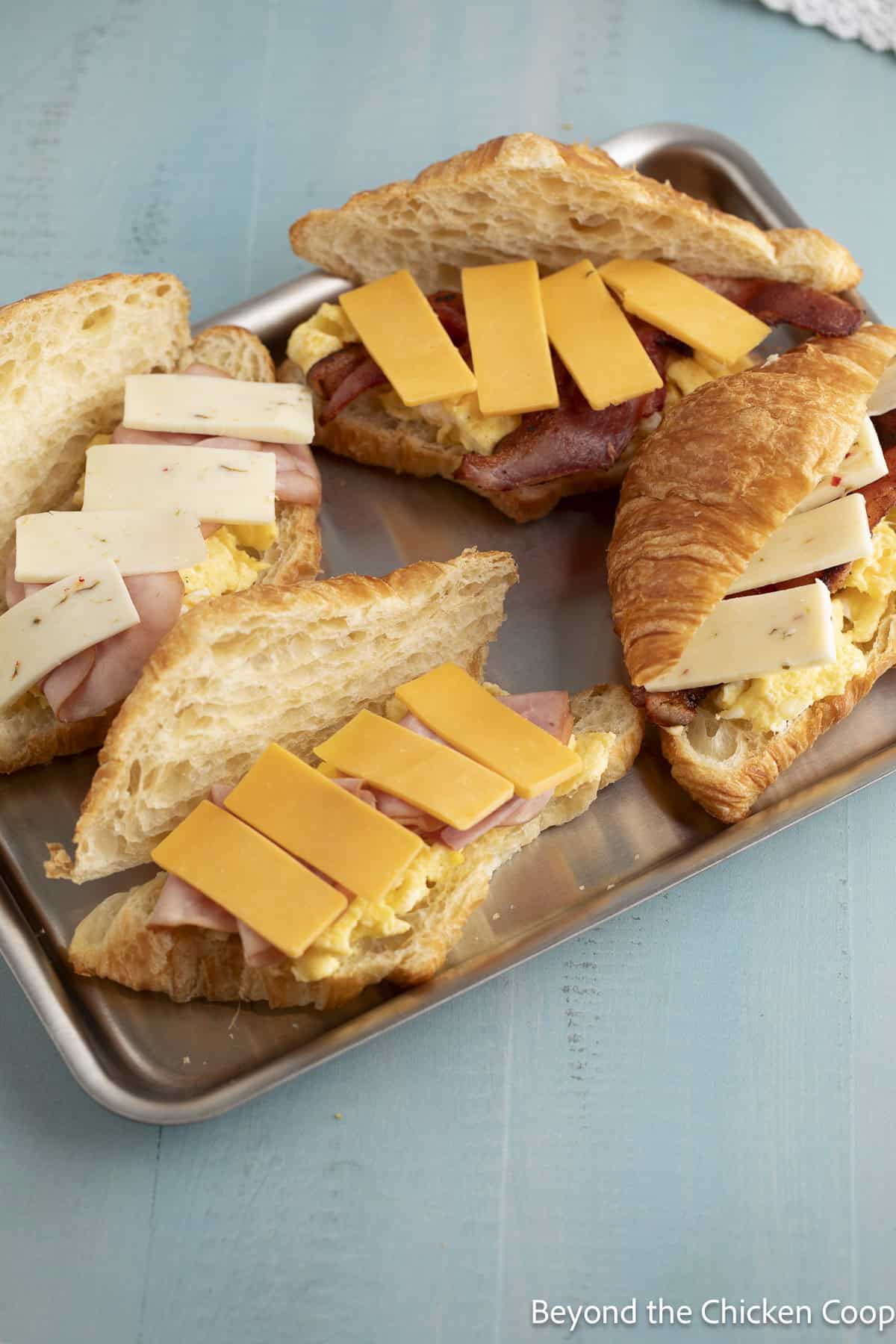 Slices of cheese on top of a sandwich.