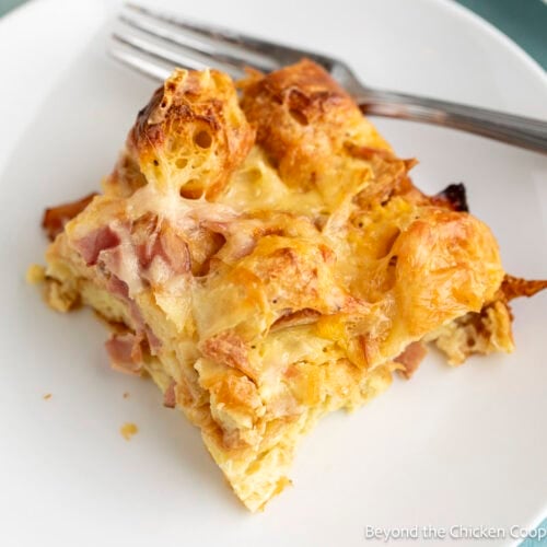 A slice of Croissant Breakfast Casserole on a white plate.