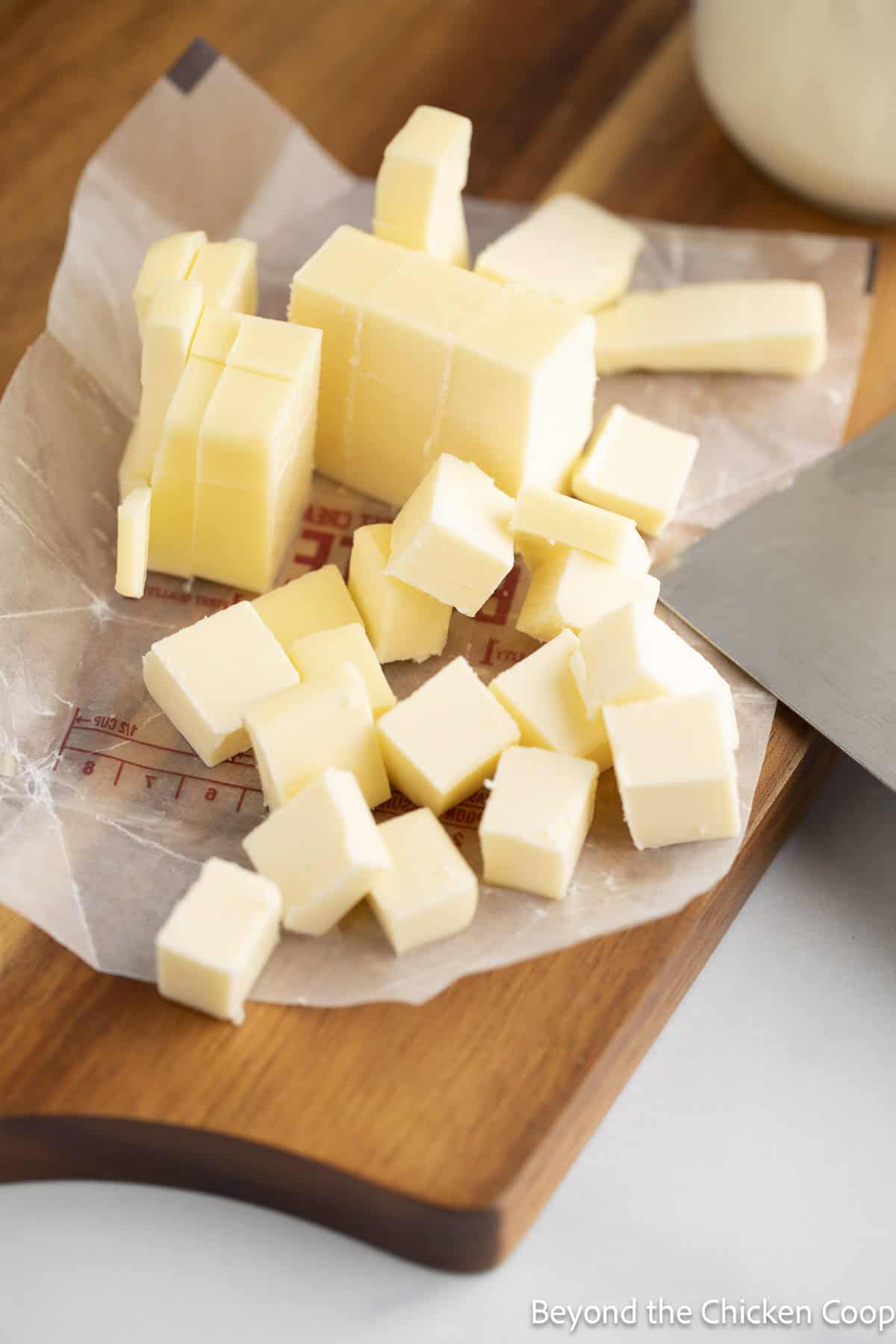 Cubed butter on a wooden board.