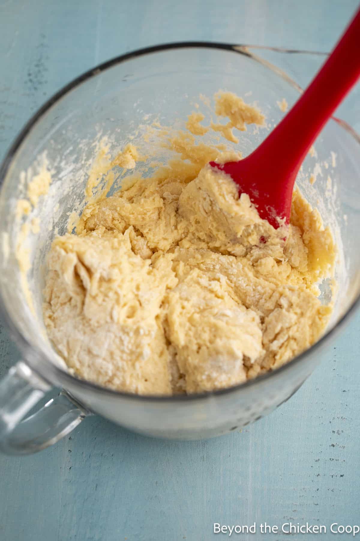 A thick muffin batter in a glass bowl.