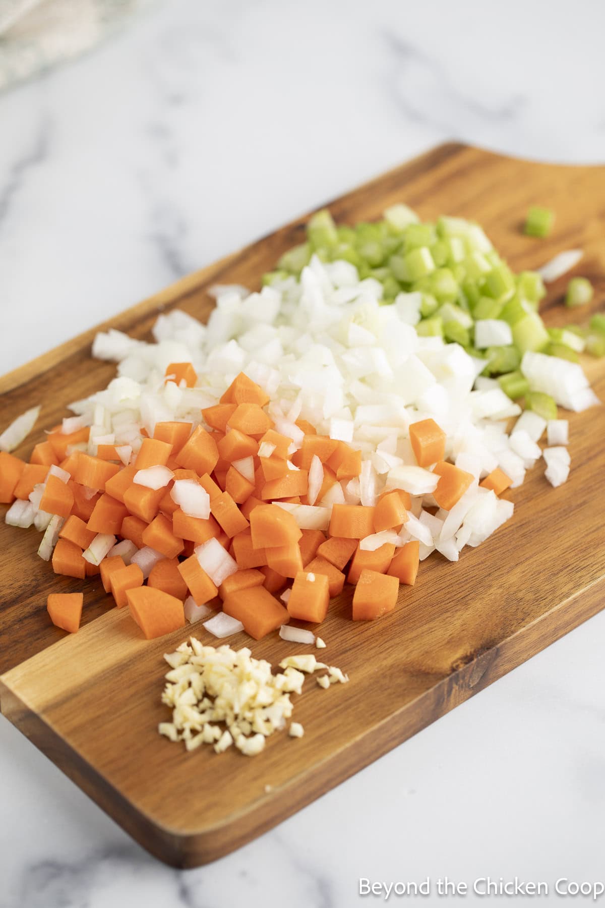 Chopped veggies on a wooden cutting board.