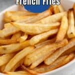 A plate filled with golden french fries.