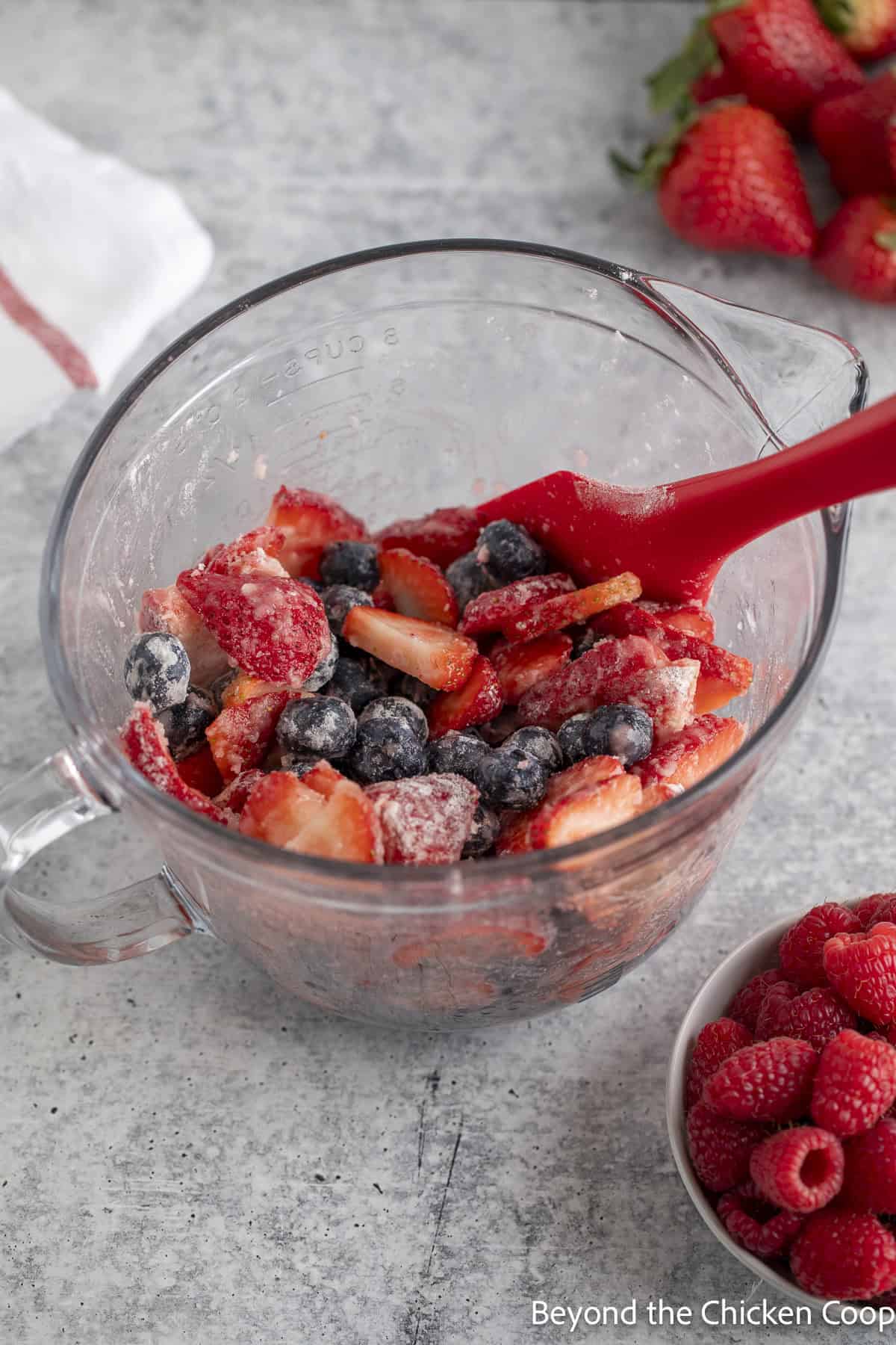 Strawberries and blueberries in a glass bowl.