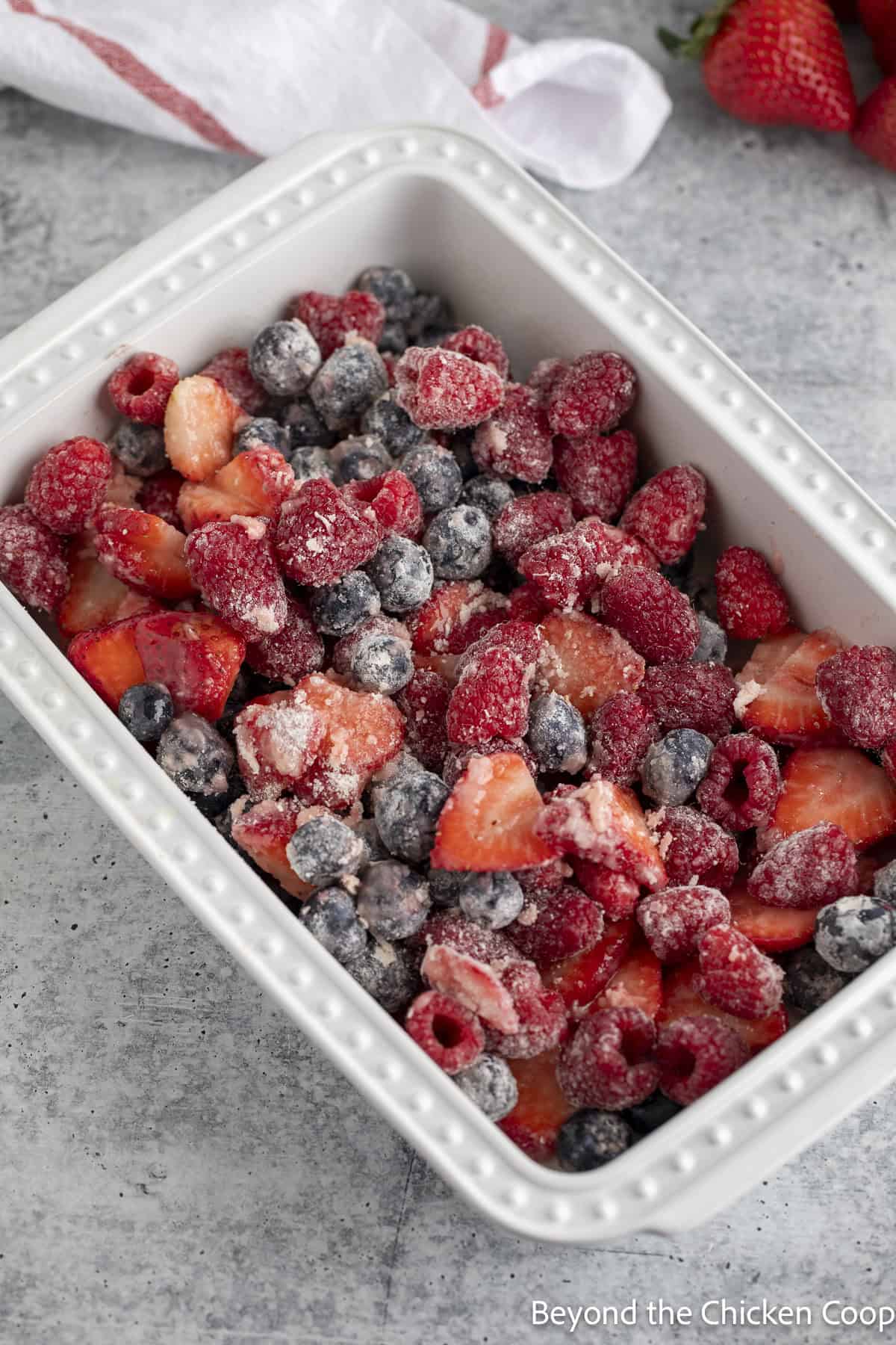 Berries in a white casserole dish.