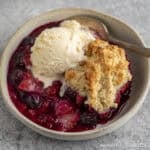 Triple Berry Cobbler topped with a scoop of ice cream.
