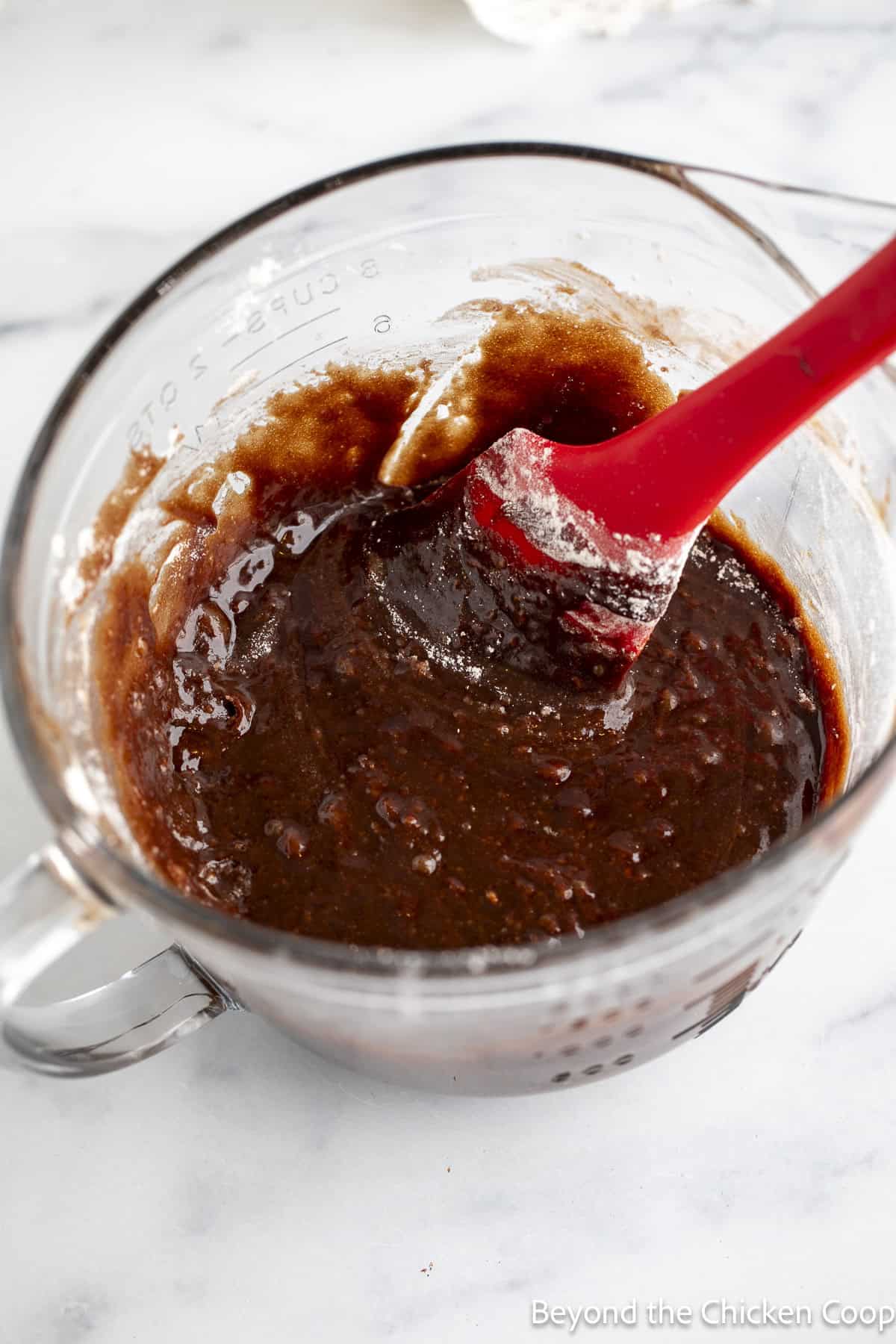 Brownie batter in a glass bowl.