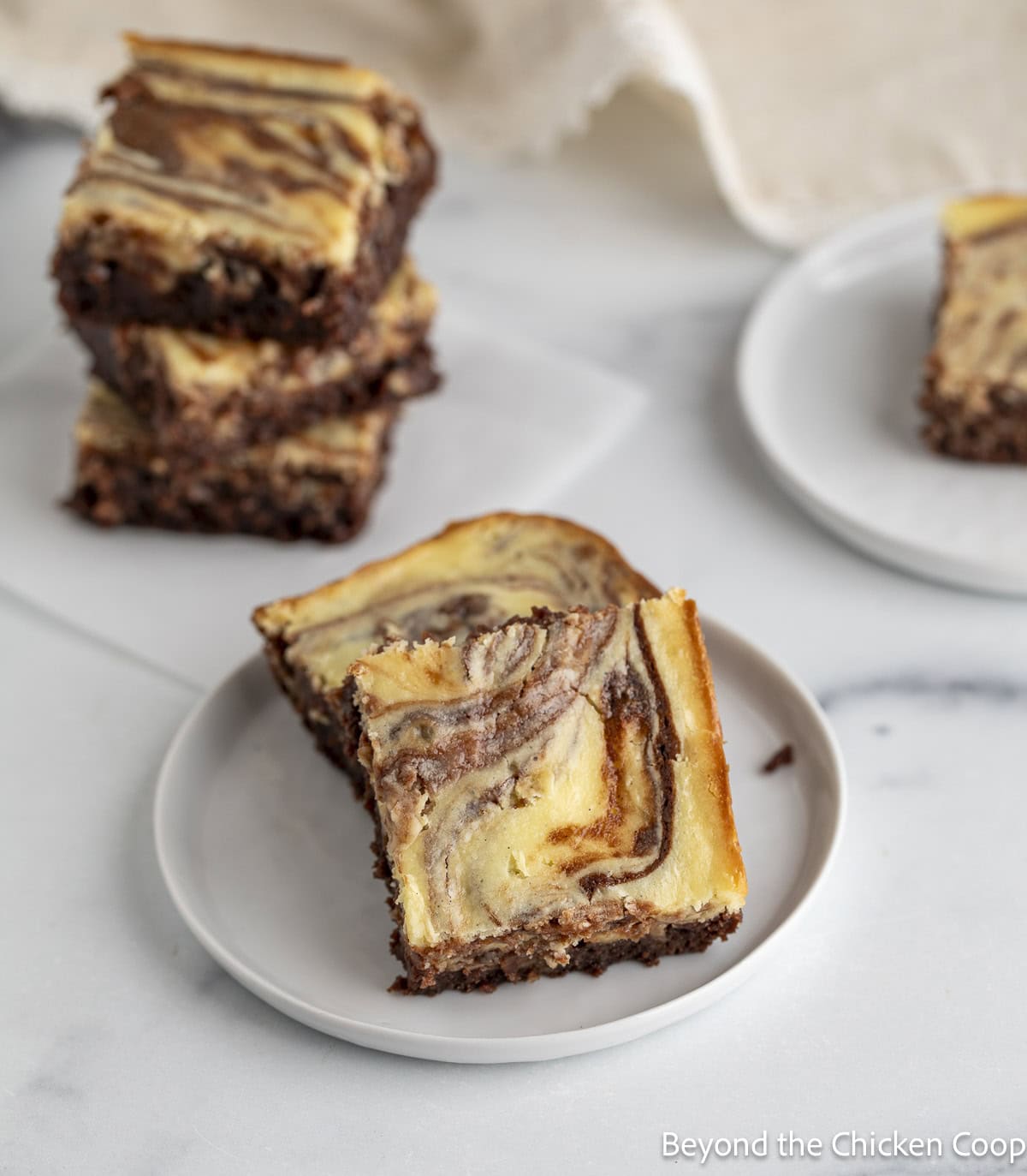 Cream cheese brownies on a small plate.